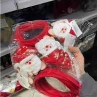 Accessori natalizi rossi: cerchietti con fiocchi bianchi, decorazioni in tessuto per capelli, confezionati in plastica.