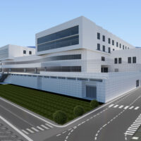 Edificio moderno a più piani con facciata bianca e grandi finestre, parco e strada asfaltata in primo piano.